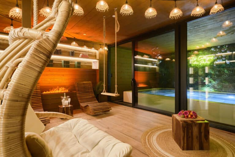 Salon avec cheminée face à la piscine privative du Cottage Scandinave à Roubaix